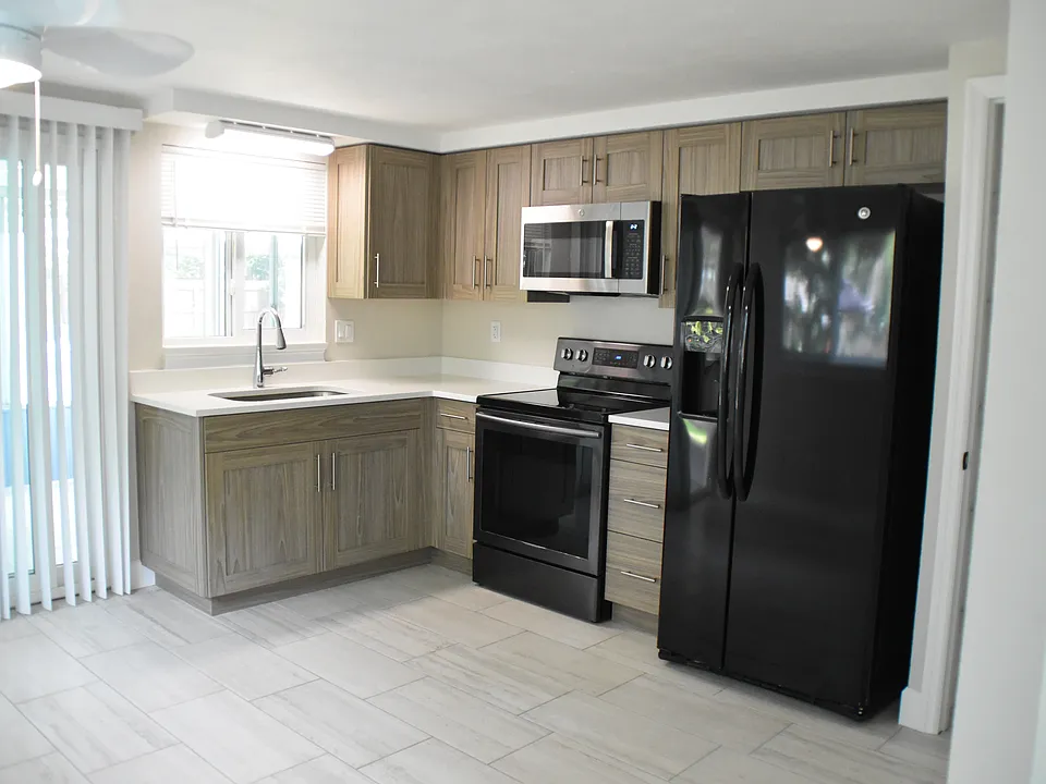 New kitchen cabinets and solid quartz countertops, oven, refrigerator, and microwave