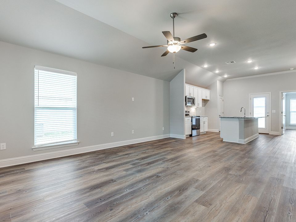 Bright living room with open layout connected to kitchen.
