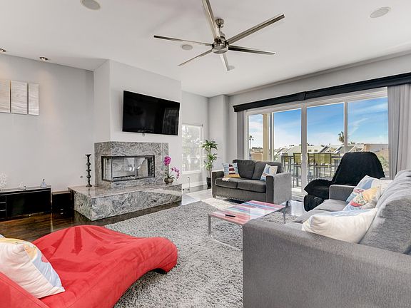 The living room features expansive glass doors that open directly onto the private deck, creating a seamless indoor-outdoor flow. Step outside to enjoy stunning lagoon views, making it the perfect space for both relaxing and entertaining.