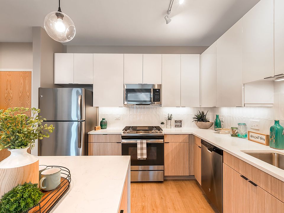 This contemporary kitchen at Eleven33 pairs sleek finishes with natural warmth quartz countertops, stainless steel appliances, and smart design made for real life.