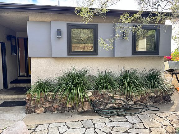 front yard. Kitchen windows with wide sills looking out, fenced in
