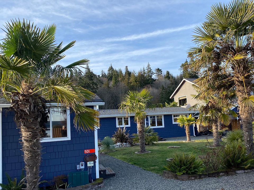 Storage Shed in front of house with Car Port