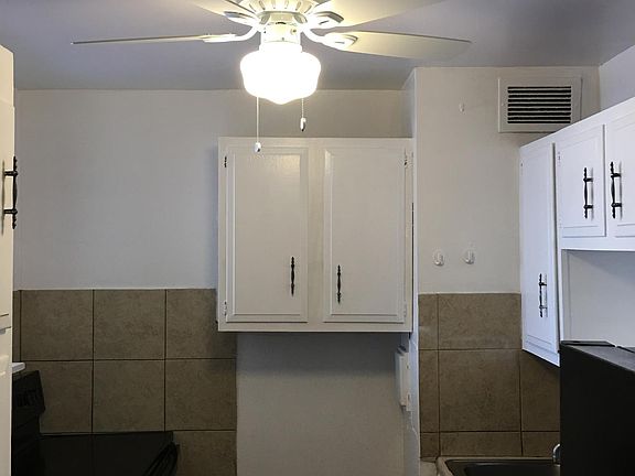 Kitchen with new appliances: Black's stove, dishwasher and refrigerator.