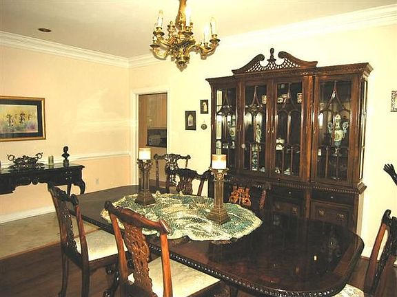 Dignified dining room boasts hardwood flooring, easy access to kitchen.