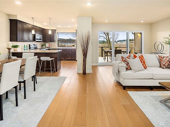 Light-filled remodeled kitchen opens onto living and dining areas and view deck.