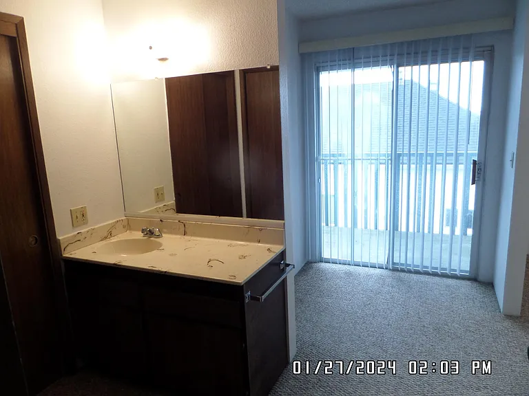 Vanity in Bedroom with small outside balcony