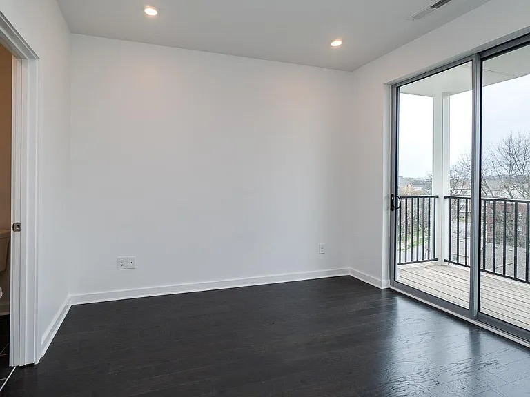 Master Bedroom with Glass Sliding Doors and Walkout Deck.