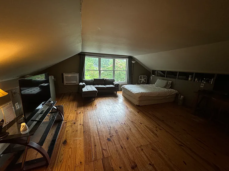 Wide angle of bedroom - storage cabinets run the length on both sides