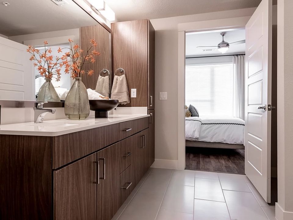 Finish Package I bath with white quartz countertops, dark cabinetry, and hard surface flooring