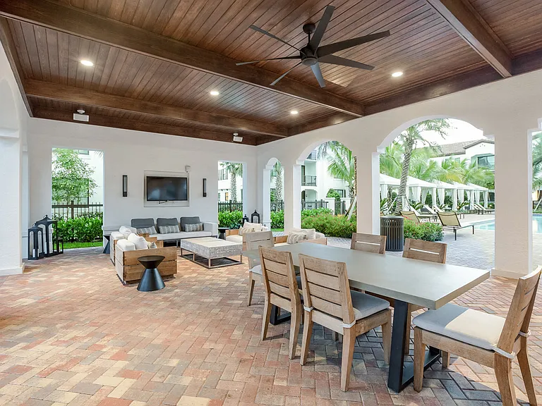 Enjoy the patio lounge with tables, couches and a big screen TV