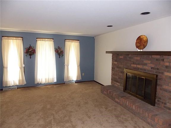 The brick fireplace in the living room is wood burning, however, the family did not burn this one since mom didn't want the mess