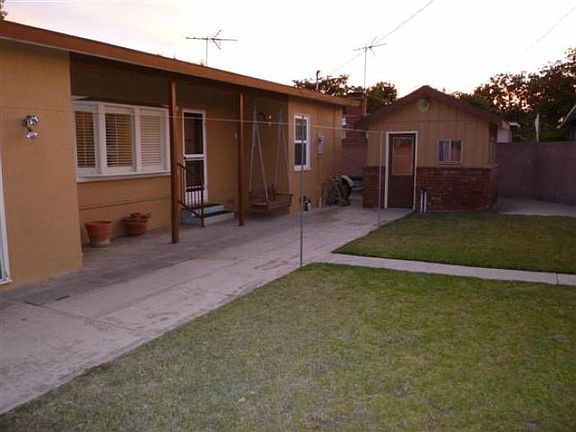 Backyard with detached small bonus room.