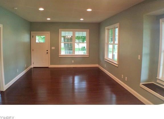 Living room view from dining room to front of home. Recessed lighting on separated switching provides custom lighting configurations.