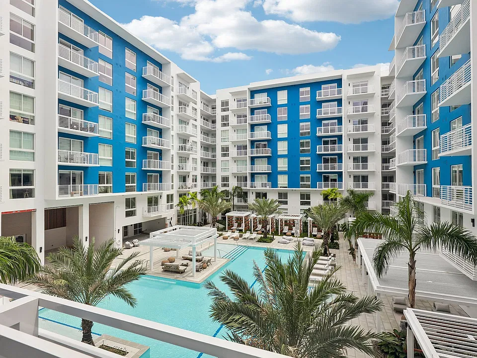 Heated zero-edge saltwater pool with sundeck, cabanas, fire pits and water feature