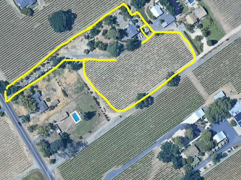 nearly 4 acres, working vineyards on two sides. Barns not included: used by owner who lives next parcel over.