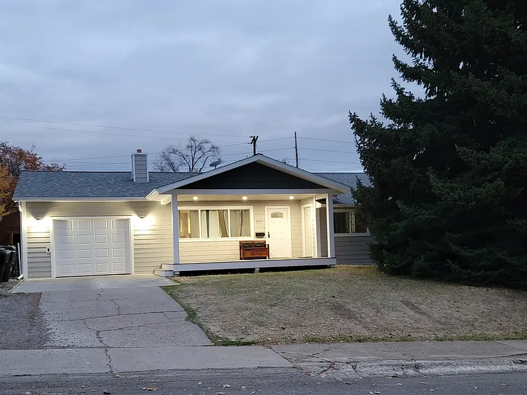 Front of house with deck lights on.