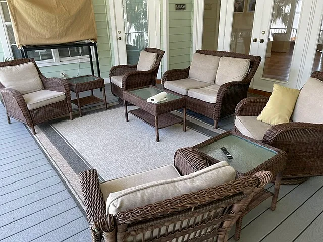 This is the main screened porch with its decking and porch furniture and big screen TV. The foyer with its wet bar is just beyond the white French doors.