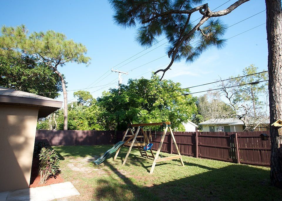 Fenced Backyard with Swing set