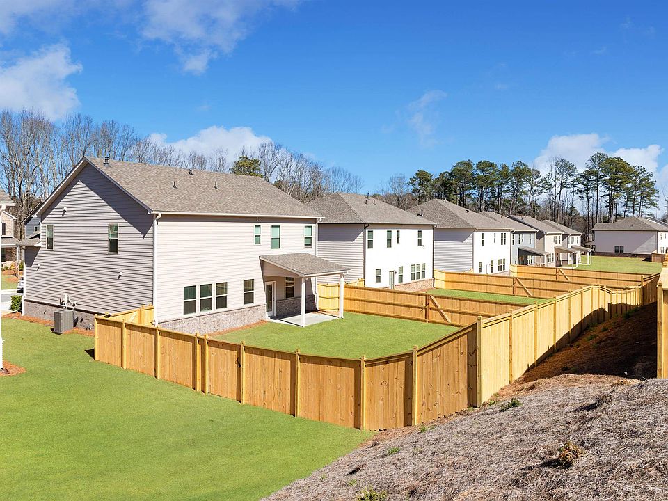 Exterior view showcasing the spacious and beautifully landscaped backyards of Baxter Woods Homes.