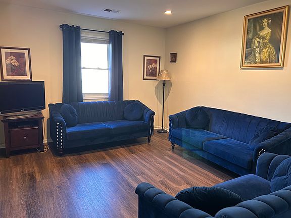 Walk up to the living room and dining room combination with recess lighting.