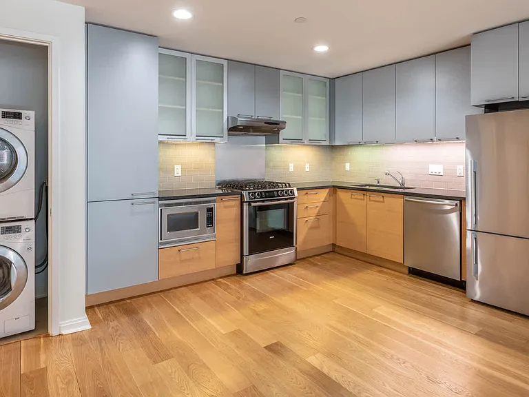 Kitchen with Stainless Steel Appliances and In-home Washer and Dryer