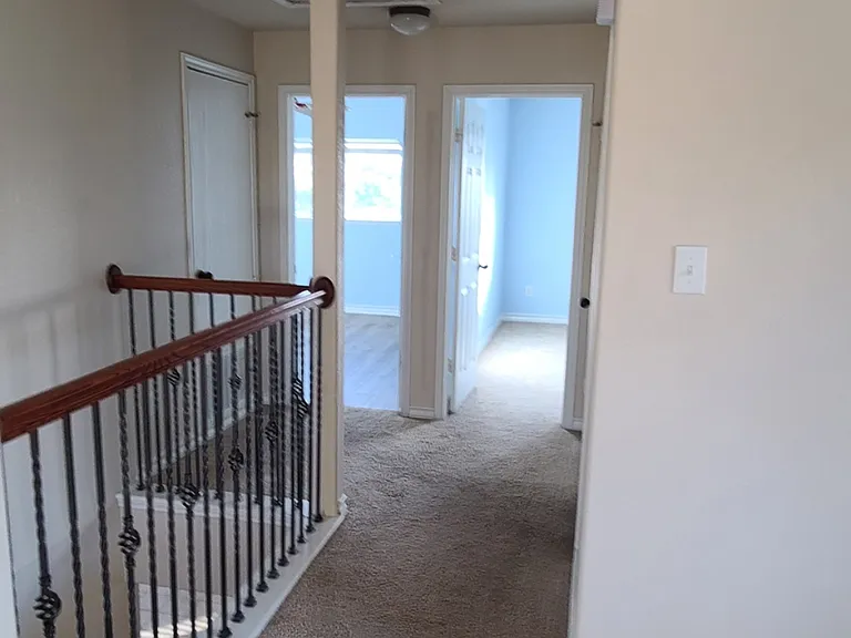 Another view of bedrooms 2 & 3. /rooms have been repainted back to neutral color. Bathroom is off to the right of bedrooms.