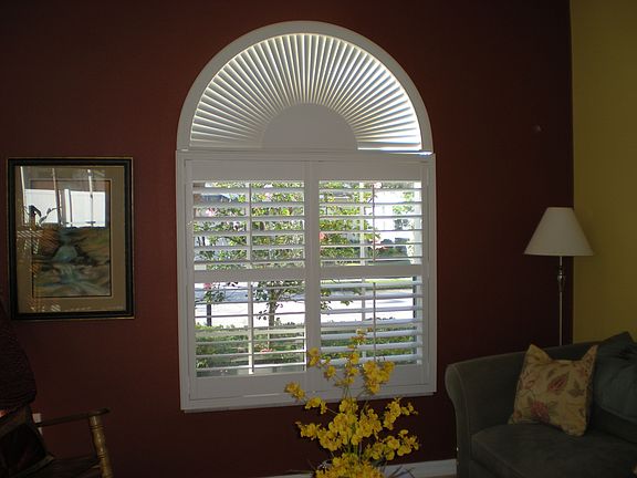 Plantation shutters compliment this pretty arched window!