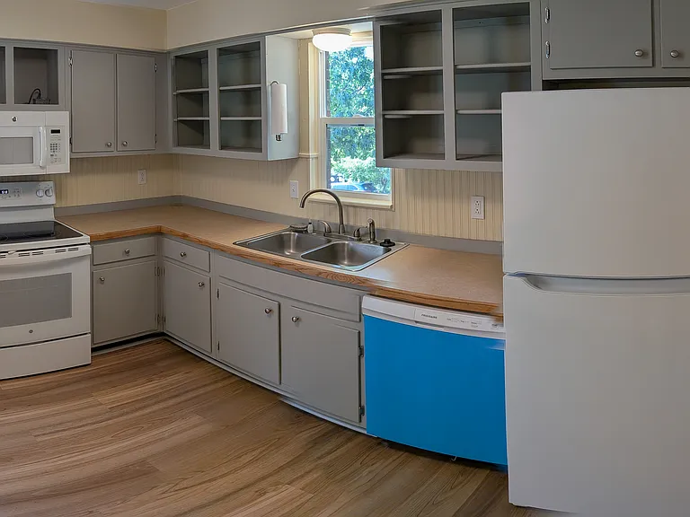 Kitchen, doorway into living room (right), front door (far right) - panoramic