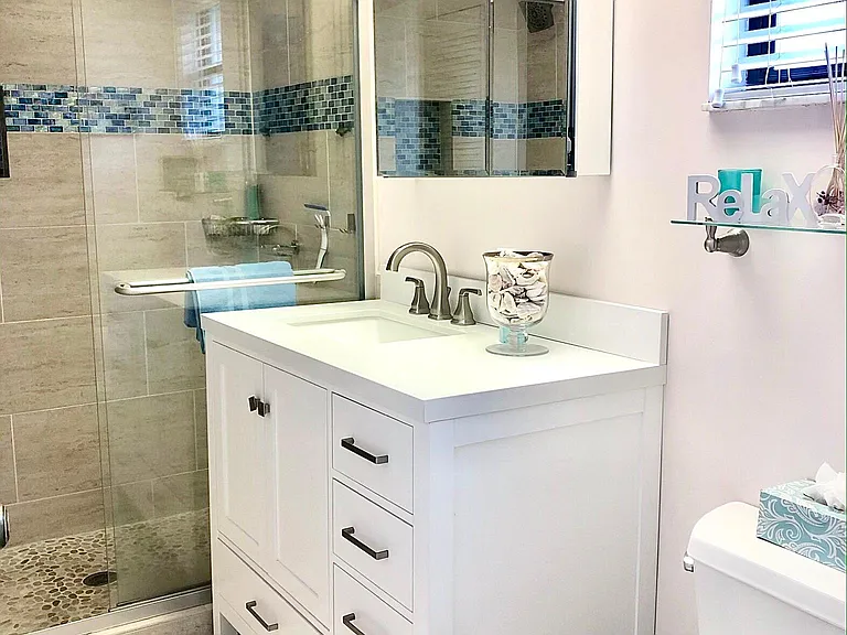 Newer master bathroom w/quartz countertops. Stone-floor spa type shower.