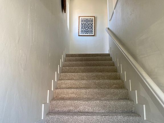 Private entrance with indoor stairway.