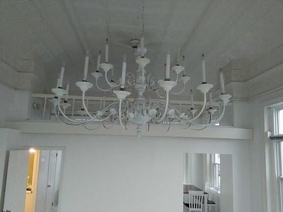 Visible from every corner of the apartment, the bulbs of the six-foot diameter marvel point upward toward the loft's original tin ceilings