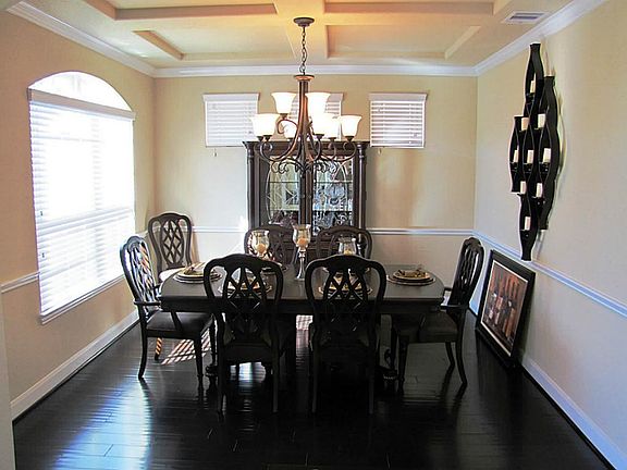 Dining room, chair rail, wood flooring, and great detail with ceiling beams.