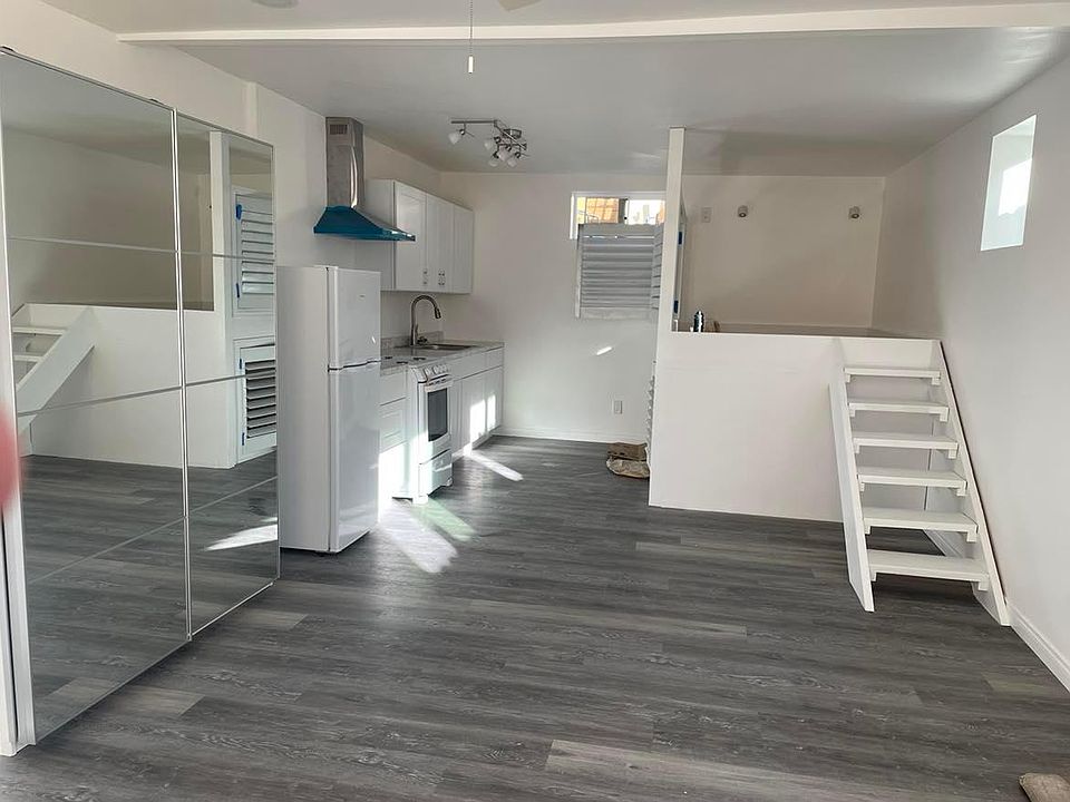 Newly installed queen platform bed with privacy screening. Double armoire with mirrored sliding doors