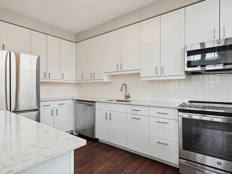 Open kitchen with stainless steel appliances and granite countertops