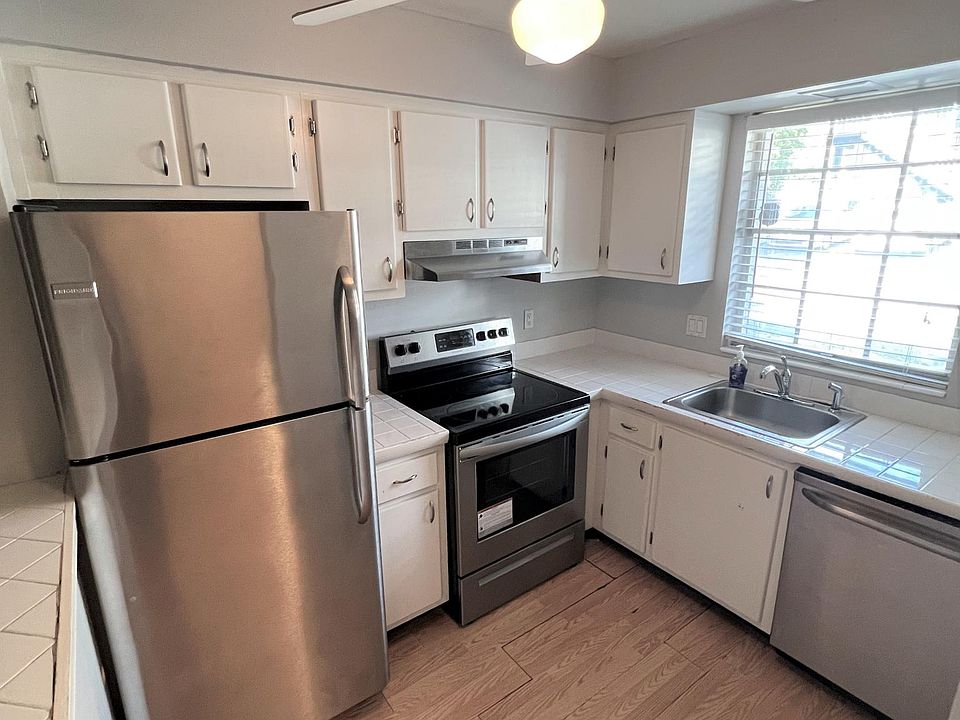 Kitchen includes fridge, oven, and dishwasher.