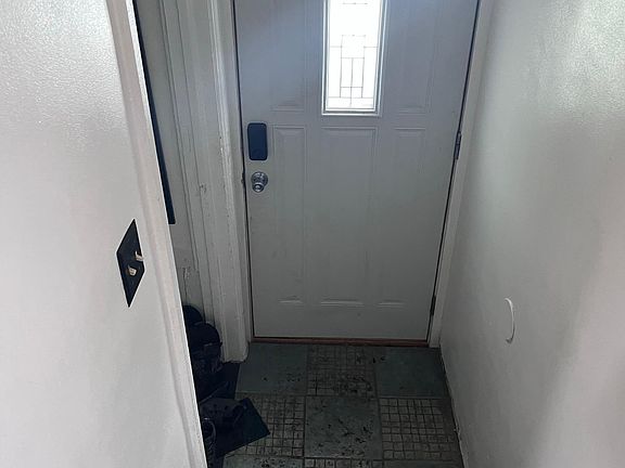 Primary door leading directly to driveway, patio and garage