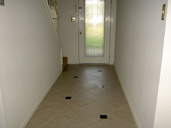 View of the beautiful glass door and ceramic tile floor with granite inserts