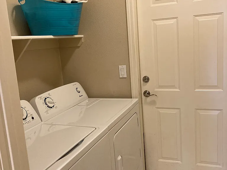 Laundry room with brand new washer and dryer set.