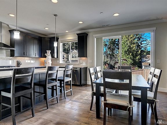 The spacious kitchen features a huge center island with breakfast bar seating, maple, chocolate stained cabinetry with soft close feature.