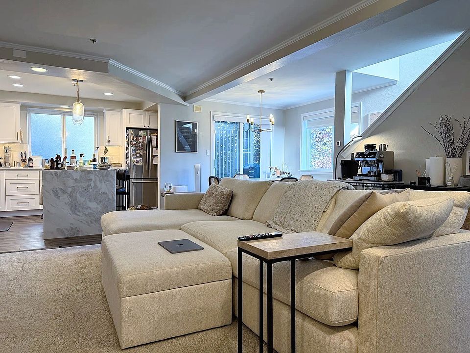 Spacious 2nd floor with living, dining, and open kitchen space. For reference, our couch is 122 inch wide.