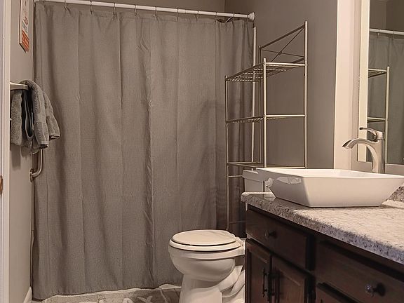 New upstairs bathroom with shower/tub, tile flooring.