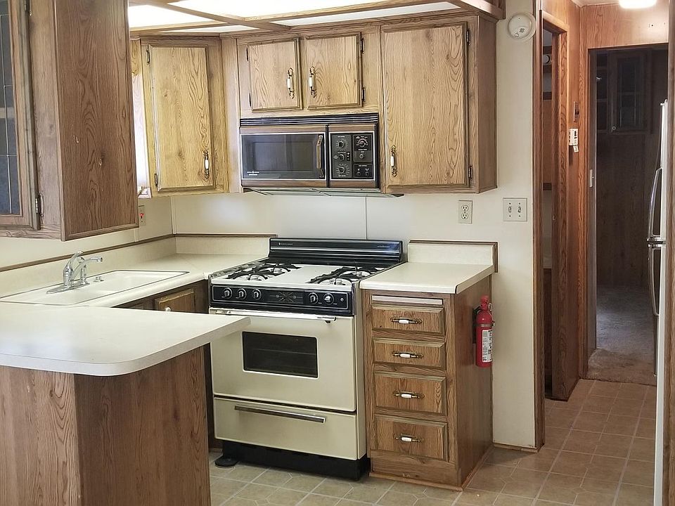 Inset lighting, microwave, newly tiled Kitchen and bathroom floor, new front door with glass storm window.