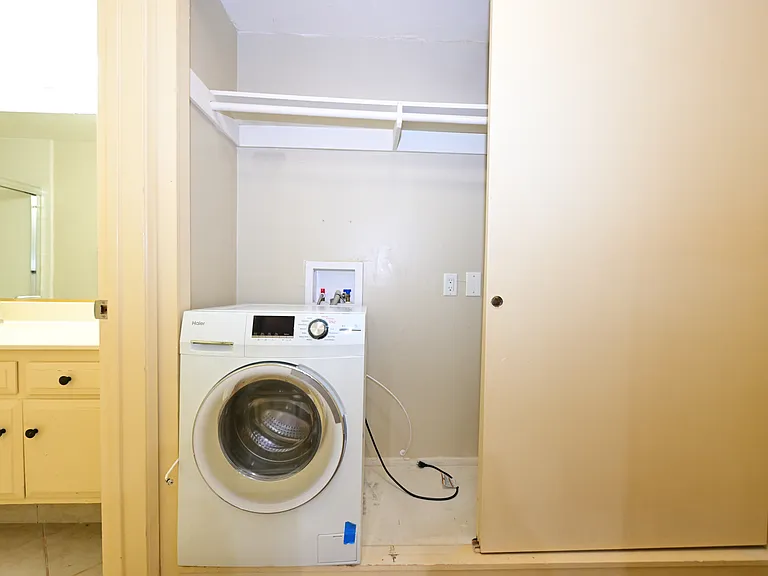 in-unit all-in-one laundry machine with plenty of storage cabinet