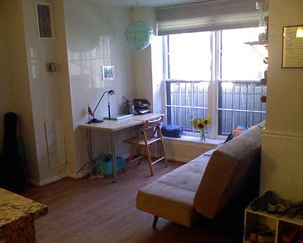 Living area with large double windows.