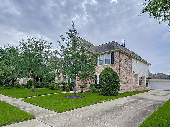 Long single wide driveway leads to the back yard and detached garage.
