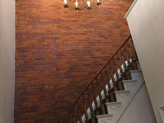 Lovely exposed brick entry and stair