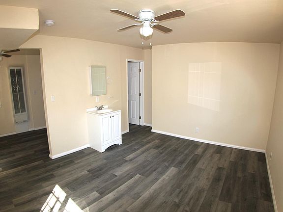 Room. Bathroom door at far end. Has shower and toilet. Too small to photograph