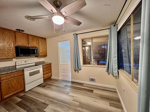 Large sunny windows in kitchen (morning sun). All windows in house have inside storm windows. New laminate flooring in kitchen.