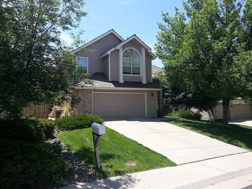 Large yard with mature trees and professional landscaping