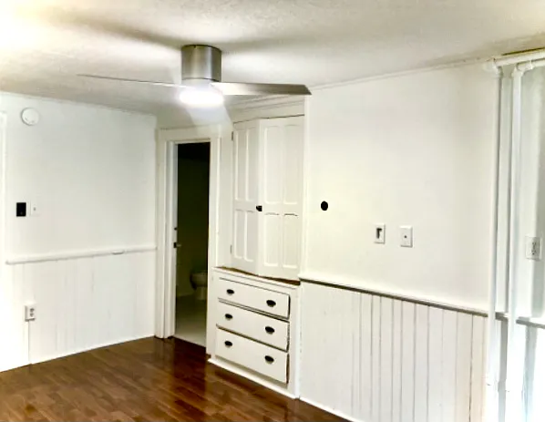 Built in cabinetry in bedroom and hookups for a flat screen tv mounted opposite bed location